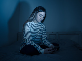 Fototapeta premium Depressed child victim of the dangers of internet and smart phone addiction.