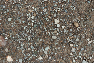 Texture gravel on the ground, small pebbles in the sand