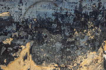 The texture of the old cracked stone wall is yellowish