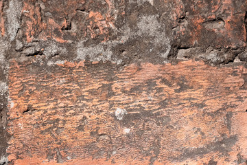 The texture of the old cracked stone wall is yellowish