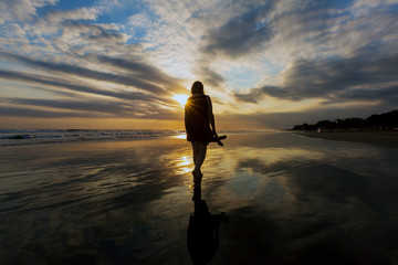silhouette of man on the beach at sunset