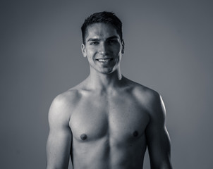 Fototapeta premium Portrait of strong healthy handsome Athletic man isolated on neutral background