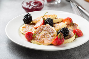 Cheesecakes, pancakes with berries, traditional Russian Breakfast of cottage cheese. Tasty sweet dessert, healthy food