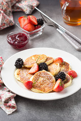 Cheesecakes, pancakes with berries, traditional Russian Breakfast of cottage cheese. Tasty sweet dessert, healthy food