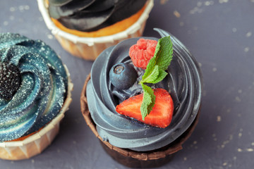 Group of cupcakes on dark background selective focus