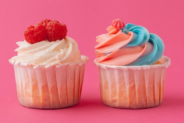 Yummy sweet cupcakes on light pink background