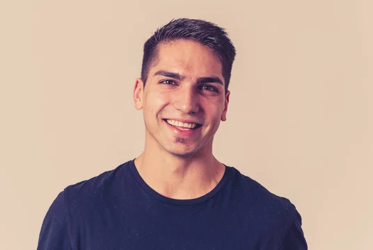 Portrait of attractive cheerful young man with smiling happy face. Human expressions and emotions