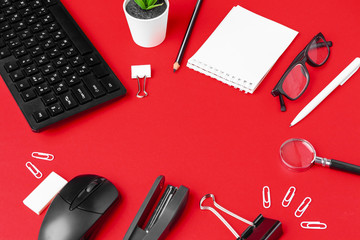 Set of stationery items on red office desk