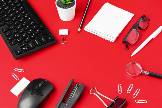 Set Of Stationery Items On Red Office Desk