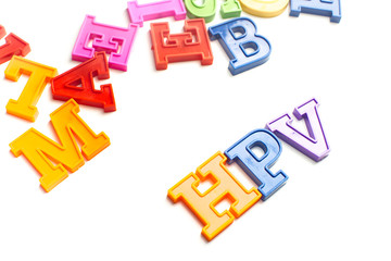Heap of plastic colored alphabet letters close up. HPV