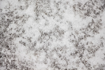 Texture of white snow on asphalt. Background of the snow for design_