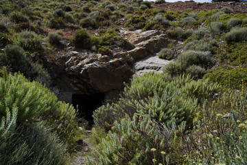 Lost places, Rusty grid barrier in front of a cave in Argientiera