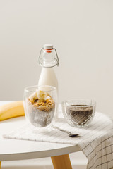 zBanana chia yogurt pudding decorated with ripe sliced banana and peanuts