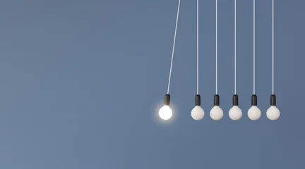 Fotobehang Mock up of hanging light bulbs with one glowing on blue wall background,Conceptual idea of pendulum,Outstanding. 3D rendering © nuchao