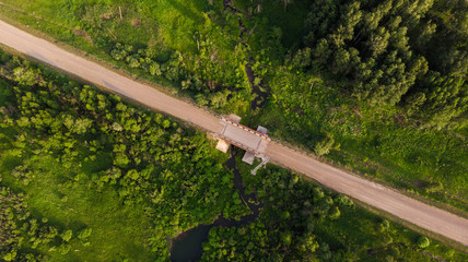Aerial view. Rural road through  small bridge surrounded by picturesque vegetation