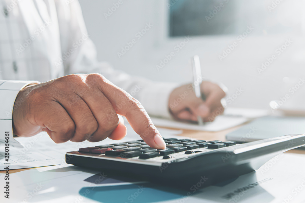 Poster close up hand of businesswoman working on desk in office and using calculator and laptop with pen fo