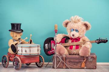 Retro Teddy Bear toys with play bass guitar and sitting on old luggage, golden microphone, bear in...