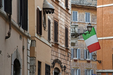 Naklejka premium Italian flag at Piazza del Paradiso, the piazza takes its name from one of the oldest medieval inns in Rome Italy