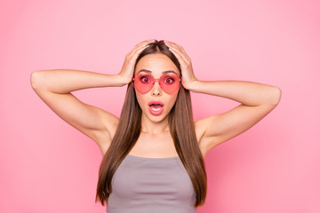 Close up photo of astonished person touching her head shouting wearing gray tank-top isolated over...