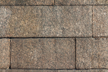 Dark brown granite stone wall texture and background. Close-Up 