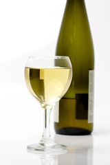 glass of white wine and bottle