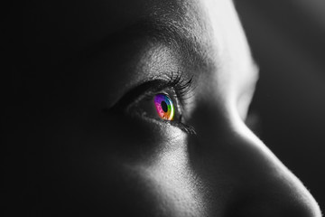 black and white shot of human with colorful rainbow eye