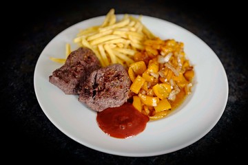 roasted steak with french fries and roasted paprika and ketchup