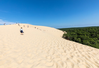  People walking on the top of the Dune of Pilat, the tallest sand dune in Europe. La Teste-de-Buch,...