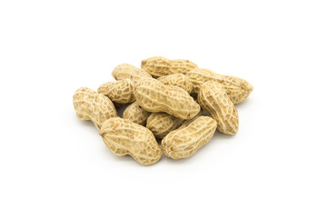Stacked fresh shelled peanuts close-up on a white background