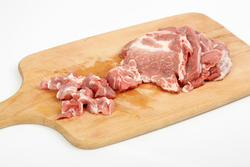 raw meat on a cutting board isolated on white