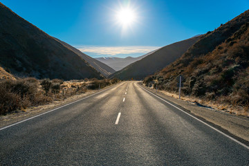 dramatic rugged barren country driving through Lindis alpine Pass in New Zealand