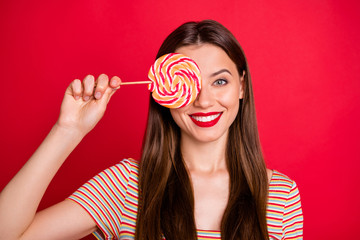 Close-up photo of glad positive nice charming dream dreamy lady teenager holding swirly caramel...
