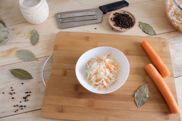 Home sauerkraut with carrots and spices on a plate, sauerkraut.