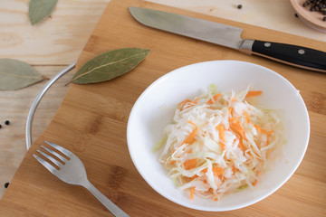 Home sauerkraut with carrots and spices on a plate, sauerkraut.