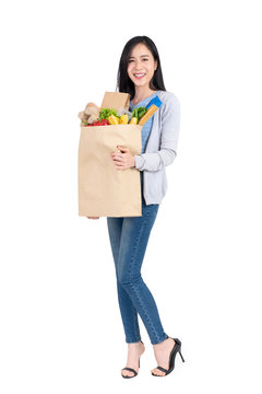 Beautiful Asian woman holding grocery shopping bag