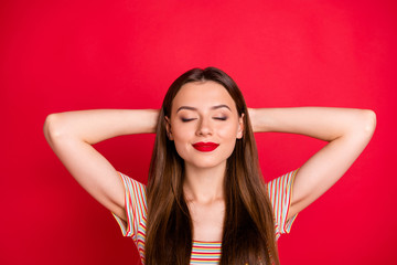 Close-up photo portrait of charming optimistic careless carefree lady having pleasant time alone holding hands behind head with closed eyes isolated bright background