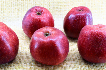 Fresh red apples with water drops on a peel