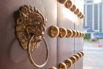 The art of red Chinese temple wooden door at ancient buildings