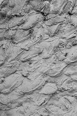 Rough cement plaster on the wall. Facade plaster background. Single-ply monolithic plaster decorative background. Single layer scraped cement plaster wallpaper. Exterior building structure backdrop.