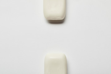 top view of white soaps on grey background with copy space