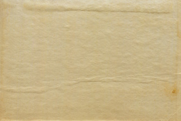 Vintage and old looking paper background. Retro cardboard texture. Grunge paper for drawing. Ancient book page.