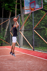 Black basketball player playing in the field