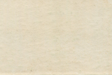 Vintage and old looking paper background. Retro cardboard texture. Grunge paper for drawing. Ancient book page.