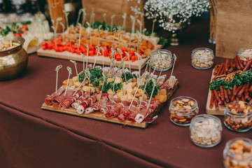 salty nuts on wooden desk on table, wedding reception. beer bar and snacks. catering in restaurant