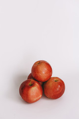 three whole red apple on a white background