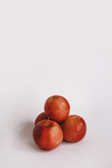 three whole red apple on a white background