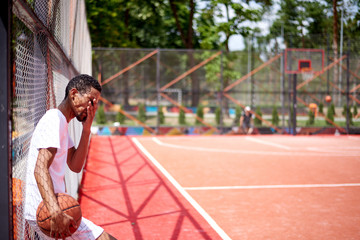 Black basketball player posing in the field outdoors