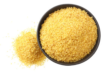 dry bulgur wheat in bowl isolated on white background. top view