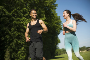 Man and woman running outdoor in a park