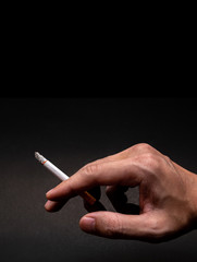 Close Up Man Handle Cigarette in His Hand for Smoing on iSolated Black Background